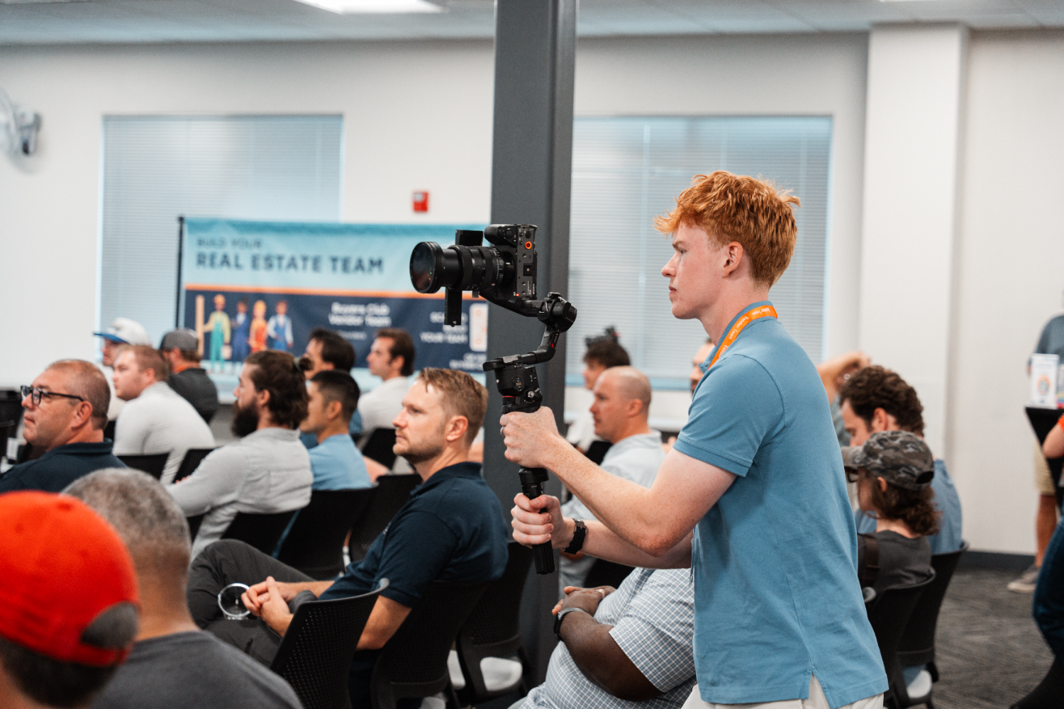 PropertyFlix videographer filming a Build Your Real Estate Team event on a gimbal